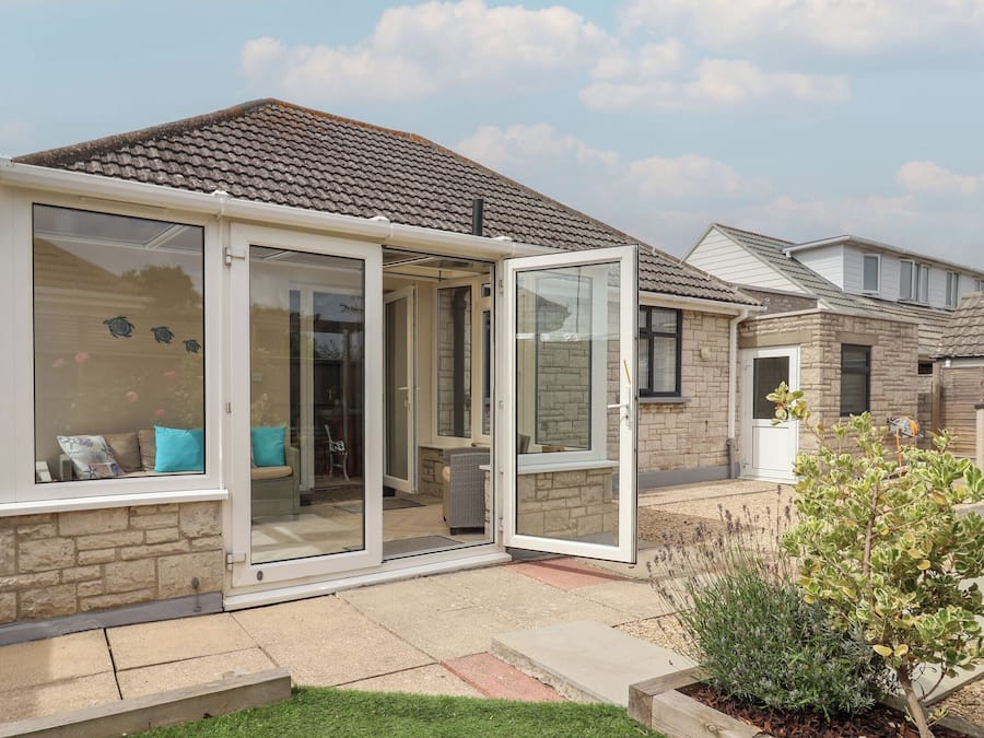 A residential property with a patio, a sliding glass door, and a brick exterior.