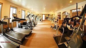A gym with treadmills, elliptical machines, and stationary bikes.