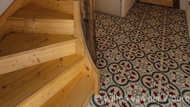 A wooden staircase with a rustic design, leading to a room with patterned flooring. - Spacious cozy and pet friendly Gîte (6pers with 3 bdrms/2 baths/3 toilets). (Claudon)
