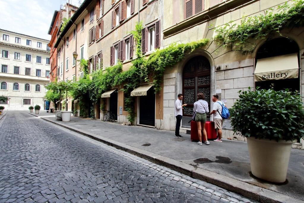 A cobblestone street lined with historic buildings, some with shops and a visible 'gallery' sign.