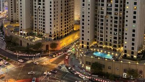 A high-rise building complex with multiple floors, a central courtyard, and a swimming pool. - Lyo hostel Marina Whraf 1 (Dubai)