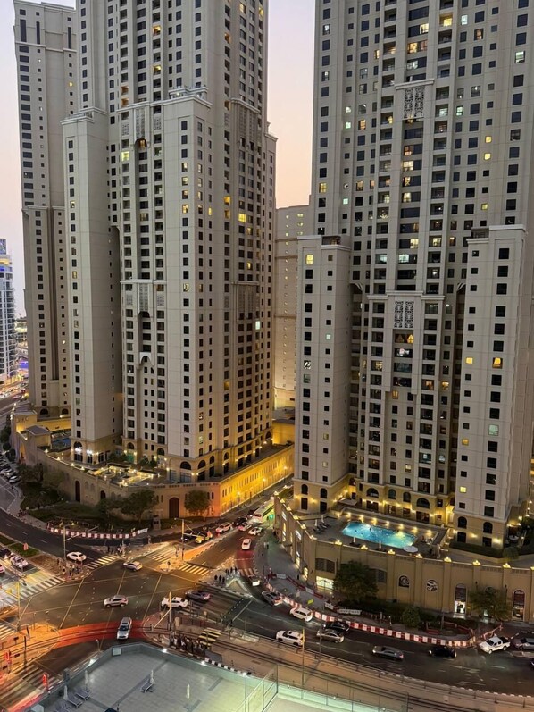 A high-rise building complex with multiple floors, a central courtyard, and a swimming pool.