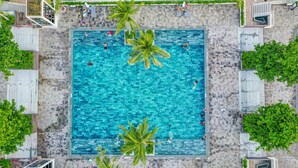 An aerial view of a square swimming pool surrounded by palm trees and lounge chairs. - V&T Hotel Phu Quoc (Phu Quoc)
