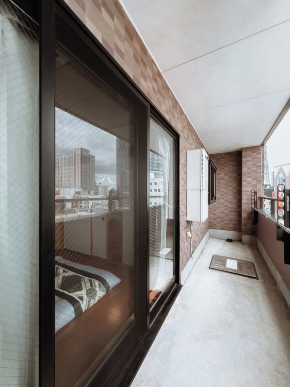 Family Suite, Balcony, City View | Desk, laptop workspace, free WiFi