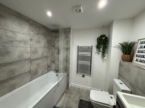 Shower, hair dryer, towels, toilet paper