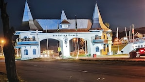 A large, illuminated building with a central archway and multiple towers.