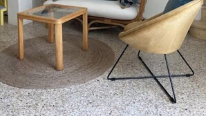 A living room with a sofa, a coffee table, and a chair. There is a map on the wall. - La petite maison du Couvent des Ecrevisses, sleeps 4 in the heart of Barjols (Barjols)