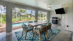 A spacious room with a pool, outdoor seating, and a TV. - Cod917 (Punta Gorda)