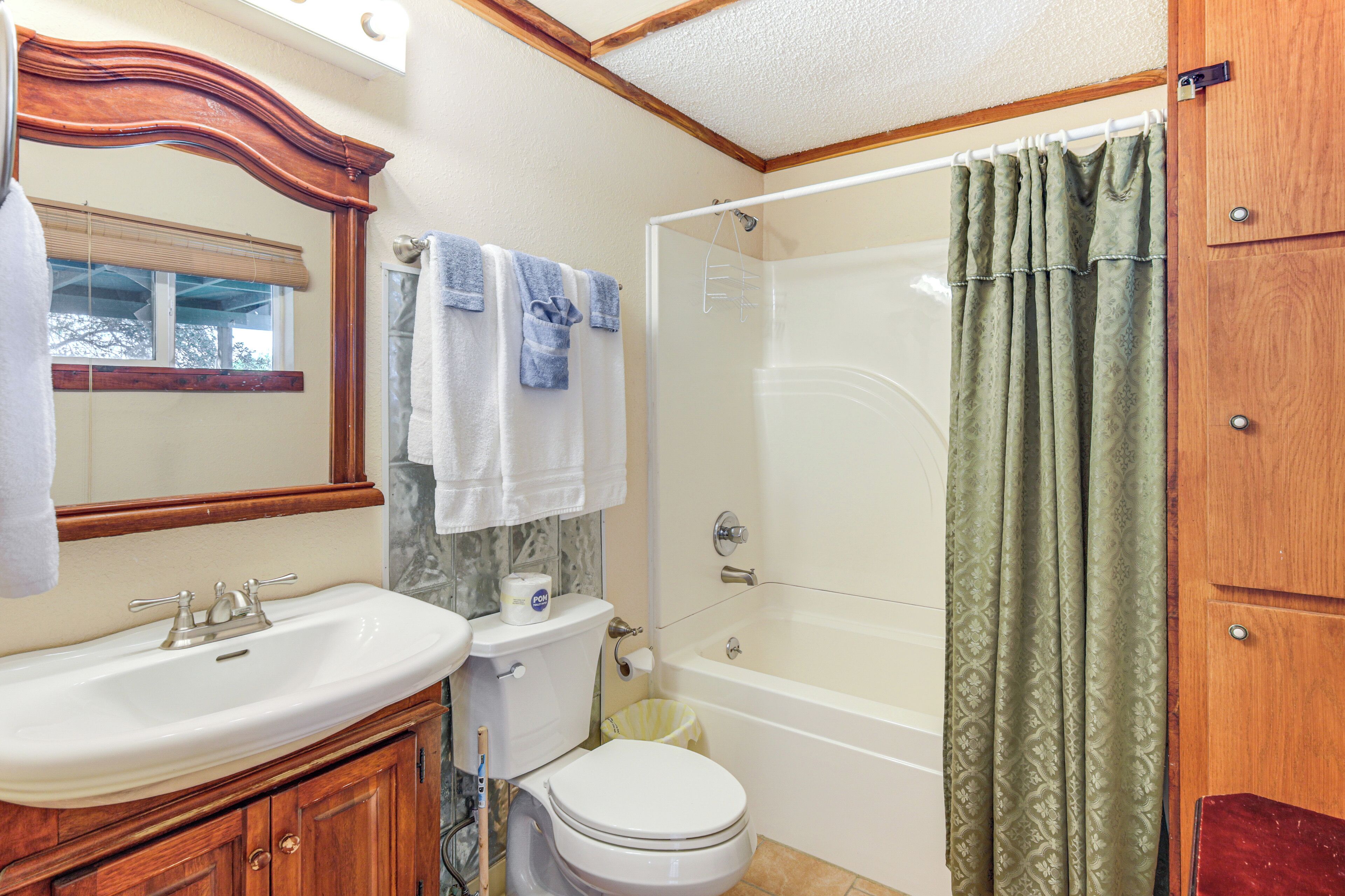 A bathroom with a sink, toilet, and bathtub.
