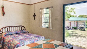 A bedroom with a bed, a window, and a view of a vehicle outside. - Studio w/ Trail Access: 8 Mi to Lake Whitney St Pk (Whitney)