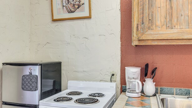 A kitchen with a stove, refrigerator, coffee maker, and a sink. - Studio w/ Trail Access: 8 Mi to Lake Whitney St Pk (Whitney)