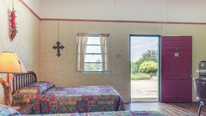 A room with two beds, a window with curtains, a door, and a lamp. - Studio w/ Trail Access: 8 Mi to Lake Whitney St Pk (Whitney)