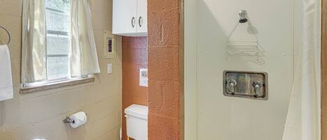A bathroom with a sink, toilet, and shower.
