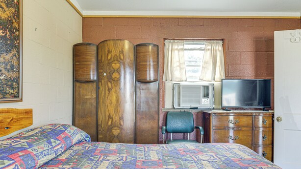 A bedroom with a bed, a desk with a television, a chair, and a wardrobe. - Easy Lake & Hiking Trails Access: Whitney Studio (Whitney)