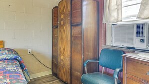 A bedroom with a bed, a wardrobe, a chair, and an air conditioner. - Easy Lake & Hiking Trails Access: Whitney Studio (Whitney)