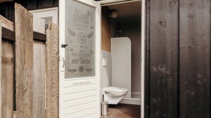 A wooden exterior with a white door leading to a bathroom. - Solglimt 2 Pers Holiday Home With Stunning Views (Callantsoog)