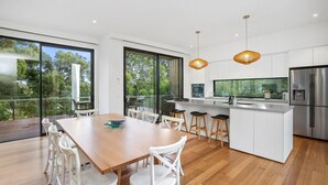 A modern kitchen with a large island, white cabinetry, and stainless steel appliances. - Anglesea Summer Escape (Anglesea)