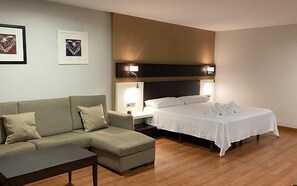 Deluxe Suite, Balcony, City View | Premium bedding, in-room safe, desk, laptop workspace