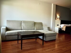 Comfort Quadruple Room, Balcony, City View | Living area | Flat-screen TV