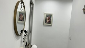 A hallway with a glass console table, a mirror, and two framed artworks on the wall. - Holiday apartment Vinaròs beach vacations (Vinaròs)