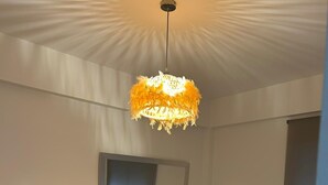 A bedroom with a bed, a nightstand, a wall-mounted mirror, and a ceiling light fixture. - Holiday apartment Vinaròs beach vacations (Vinaròs)