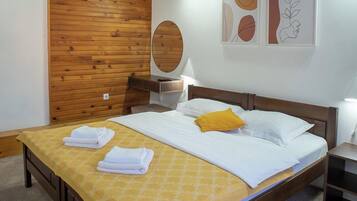 Une chambre à coucher avec un cadre de lit en bois, une couvre-lit jaune et un plafond en bois.