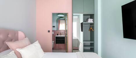 A bedroom with a bed, a wardrobe, and a television.