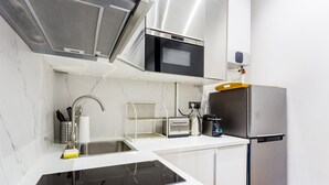 A modern kitchen with a built-in microwave, oven, and stainless steel refrigerator. - Cozy Apartment - 1br/4p - Trocadero/eiffel Tower (Paris)