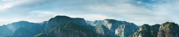 A mountainous landscape with rugged peaks and lush greenery.