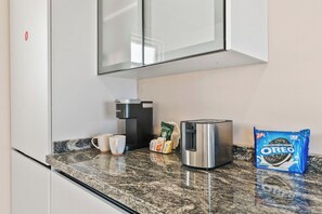 A kitchen counter with a coffee maker, a toaster, a bag of Oreo cookies, and a cup. - Pool Table * Private pool * Sleeps 16 (Oranjestad)