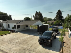 A residential garage with a black GMC truck parked inside.