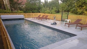 A rectangular swimming pool with a tiled deck, surrounded by a wooden fence. - 15th century castle, up to 15 pax, pool and park (Artonne)