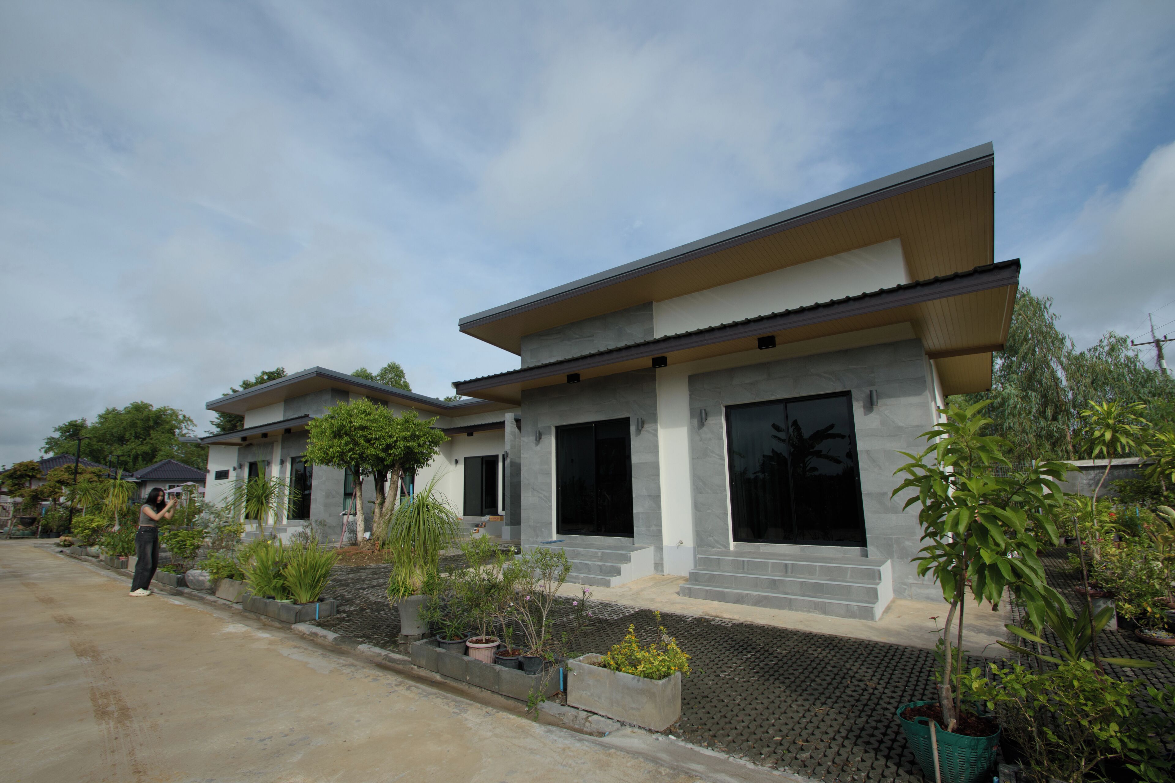 A modern two-story house with a flat roof and large windows.