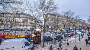 A busy urban street with a double-decker bus labeled "BIGBUS PARIS" and a white van. - Elegant Apartment - 3br/8p - Gare de L'est (Paris)