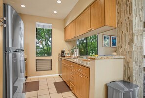 Functional kitchen with sleek countertops and natural light GCH-181