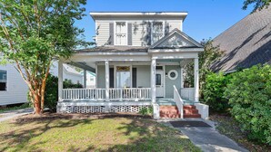 A two-story house with a porch, a front door, and a mailbox. - Historic Charm in Grand Gulfport Home; walk to beach, casino, port, aquarium (Gulfport)