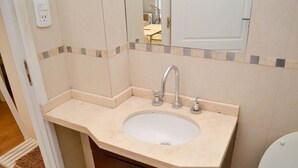 A bathroom with a sink, mirror, and a door. - Buenos Aires: Palermo. Perfect for digital nomads. (Buenos Aires)