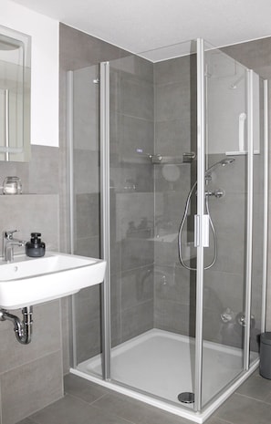 Shower, hair dryer, towels, toilet paper