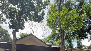 A two-story house with a covered porch and a staircase leading to the upper floor. - Perhentian Shari-la Resort Blue Star (Pulau Perhentian Kecil)