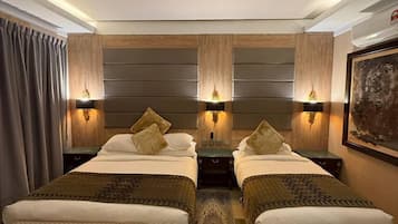 Premium Triple Room | Desk, bed sheets