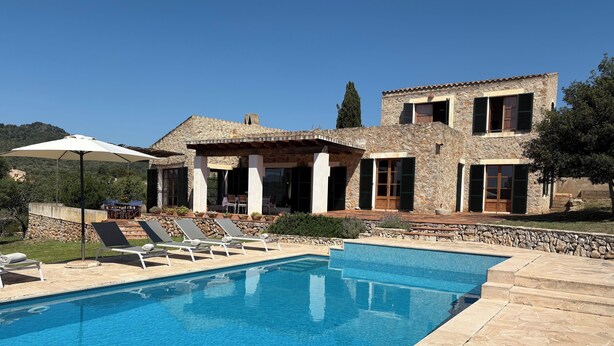 A poolside area with lounge chairs and a stone pool. - Fetget, quiet rural property with swimming pool. (IB)