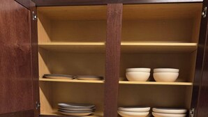 A kitchen with wooden cabinets, a white countertop, and a stainless steel sink. - Charming & Cozy 1BR/1BA/2BEDS. Pool/Gym/Shops (Frisco)