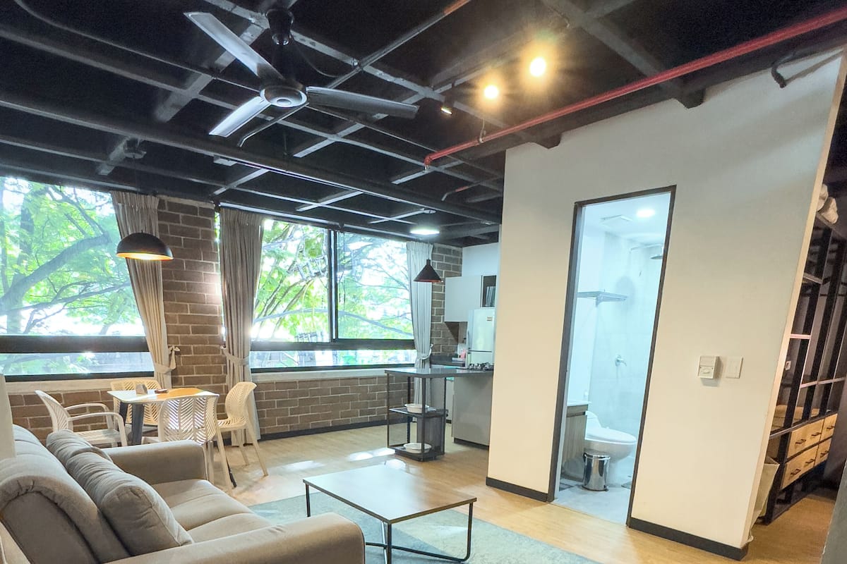 A modern interior with a sofa, coffee table, and dining area.