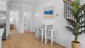 A kitchen with white cabinets, a stainless steel refrigerator, and a wooden countertop. - Spacious 4 Bedroom 3.5 Bathroom walking distance to the beach. Close proximity! (Myrtle Beach)