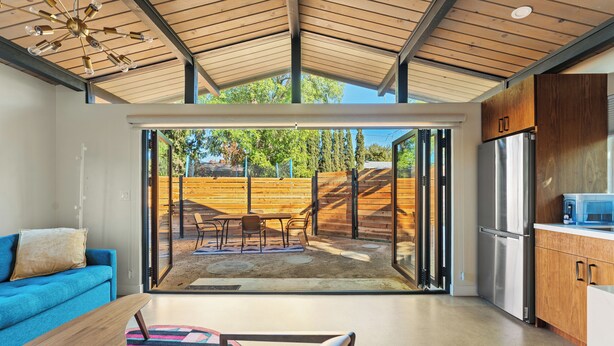 A modern kitchen with a large sliding glass door leading to an outdoor patio area. - Bright, Modern 1BR ADU in Claremont with Seamless Indoor-Outdoor Living (Claremont)