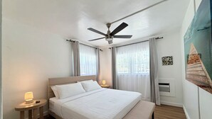 A bedroom with a bed, bedside tables, a ceiling fan, and a window with curtains. - 2237/U1-Top Pick-Beachfront-Downtown (Fort Lauderdale)