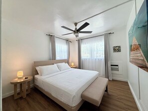 A bedroom with a bed, bedside tables, a ceiling fan, and a window with curtains. - 2237/U1-Top Pick-Beachfront-Downtown (Fort Lauderdale)