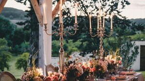 An outdoor dining area with a long table set for a meal, surrounded by wooden pillars and string lights. - Manoir Des Cedres - Eight Bedroom Castle, Sleeps 20 (Castelmoron-sur-Lot)