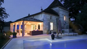 A stone house with a swimming pool, outdoor seating, and a covered patio area. - Manoir Des Cedres - Eight Bedroom Castle, Sleeps 20 (Castelmoron-sur-Lot)