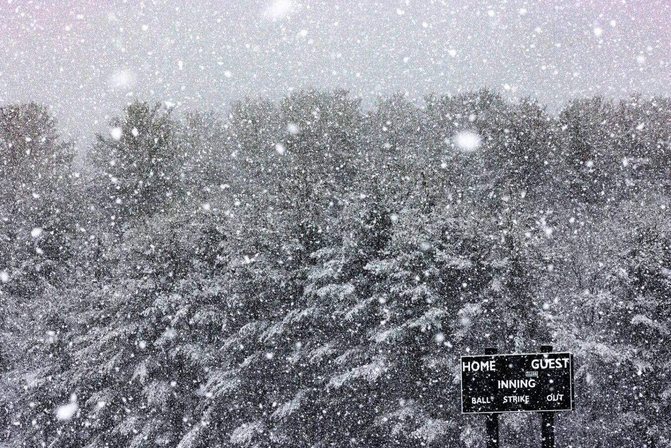 A snow-covered landscape with a sign indicating 'HOME INNING BALL STRIKE OUT' and 'GUEST INNING BALL STRIKE OUT'.